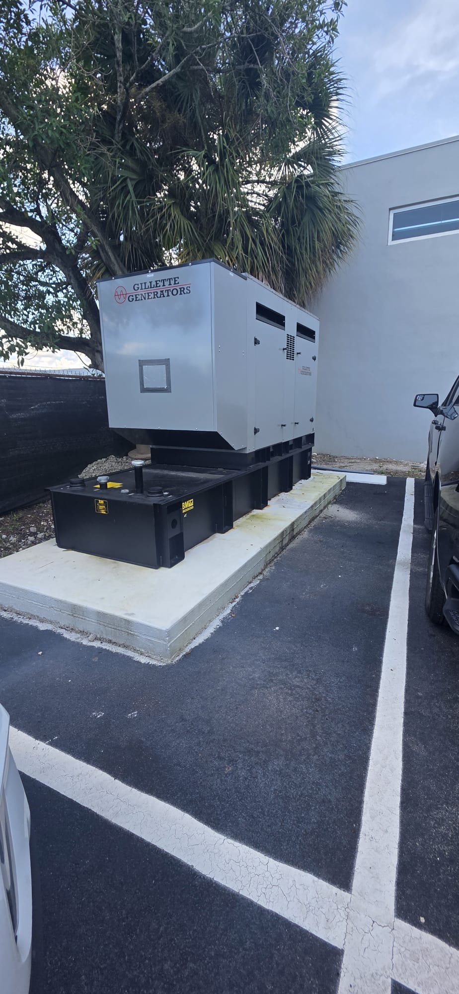 Side view of a Gillette generator and base fuel tank on a concrete pad.