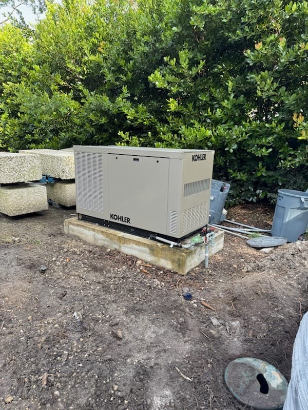 Kohler standby generator positioned on a concrete equipment pad.