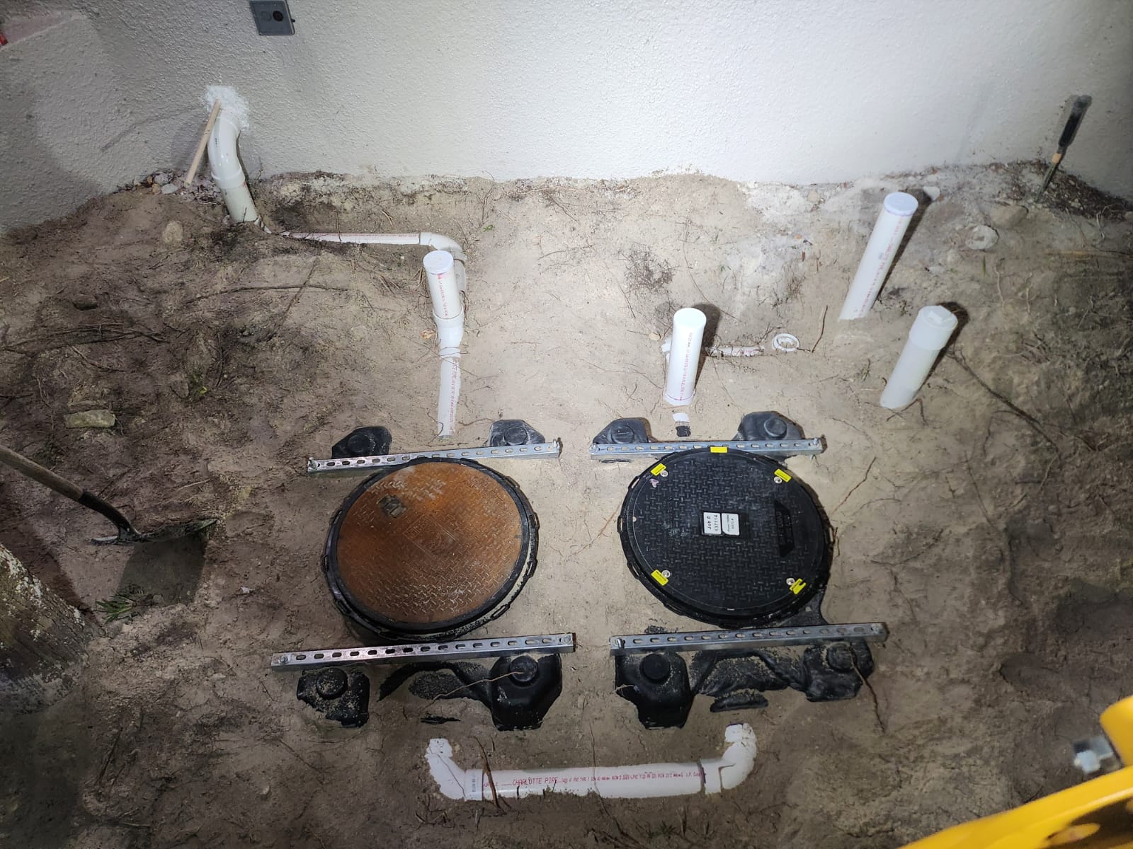 Grease trap lids and underground piping before backfill