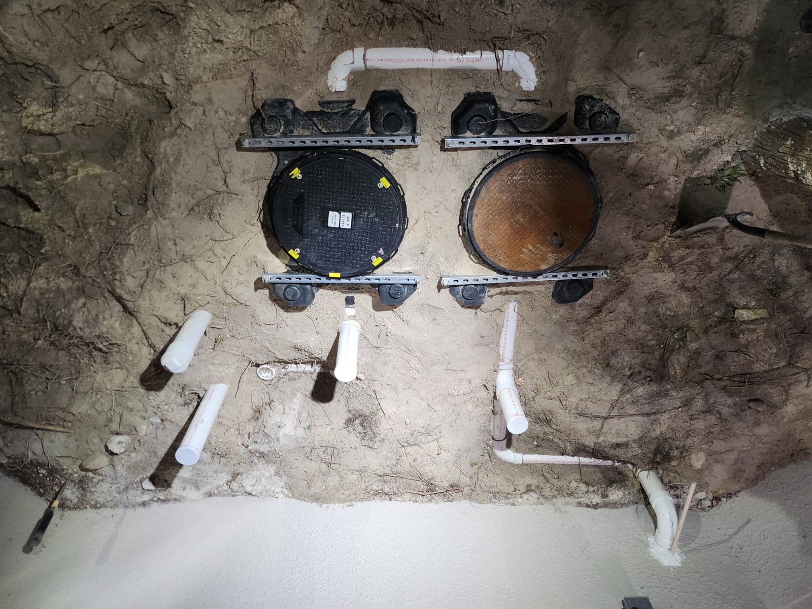 Grease trap installation top view with piping and covers