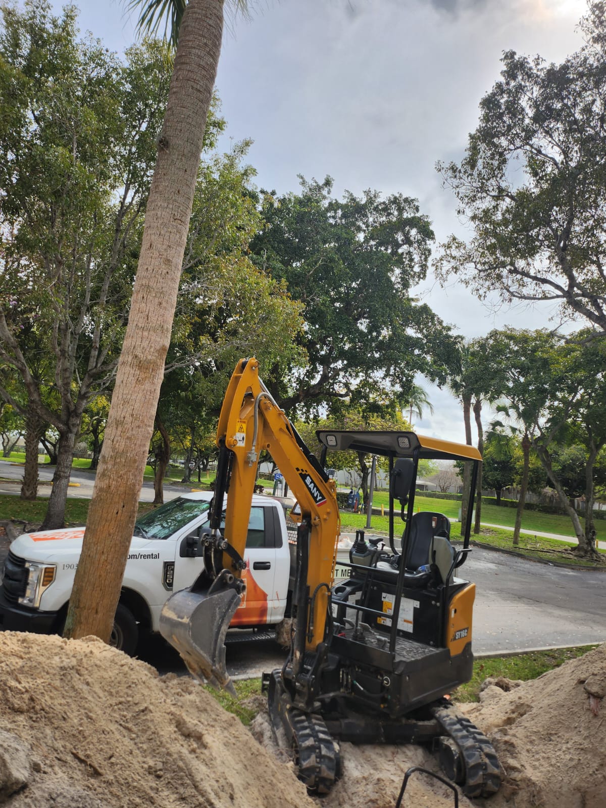 Excavator working near grease trap installation area