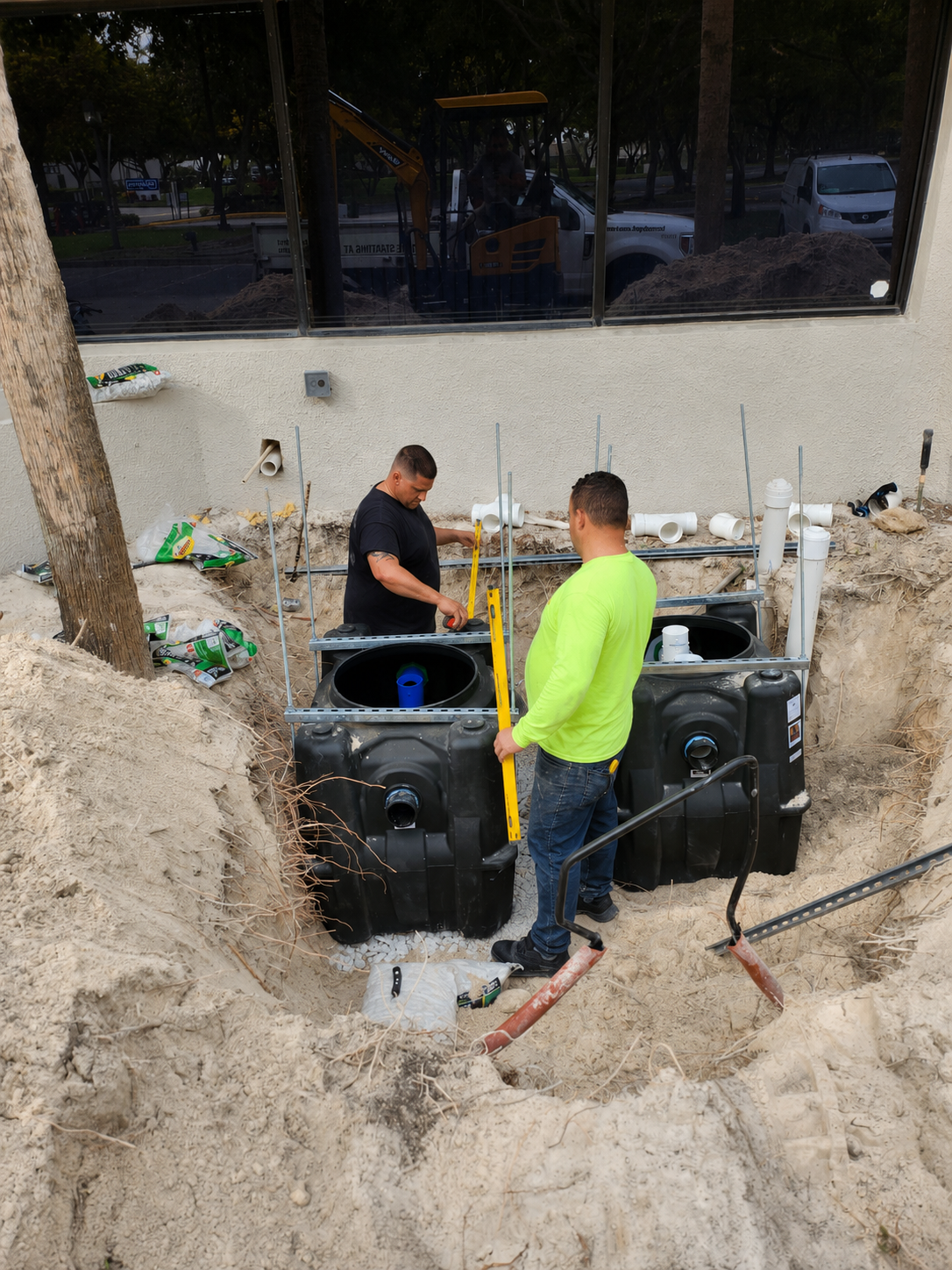 Grease trap installation at Global Meat Market with workers setting tanks